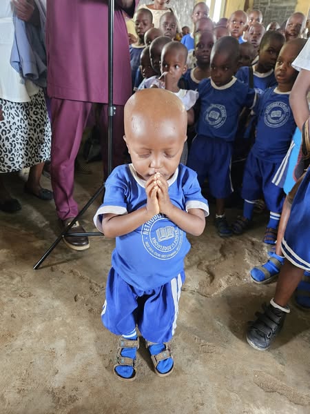 Young student in prayer during the Back to School Initiative