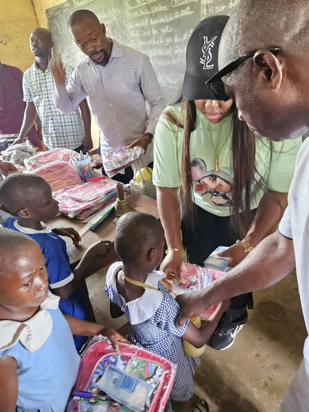 Volunteers distributing school supplies to children